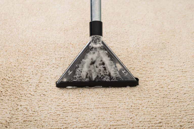 Carpet Cleaner extracting suds and water from white carpet